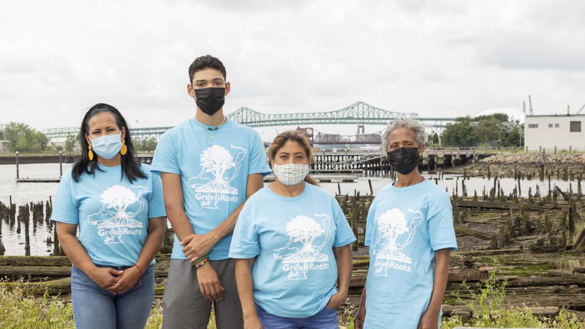 Four GreenRoots community health ambassadors in front of Chelsea Creek.