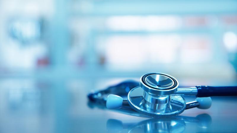 Stethoscope for medical doctor diagnosis on blue health science laboratory background.