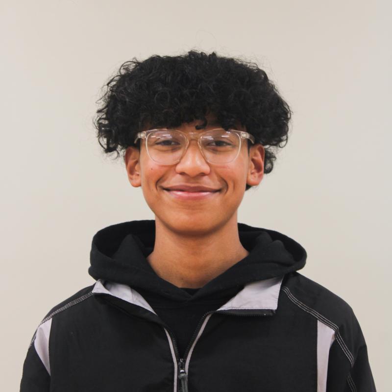 Young man smiling against a white background.